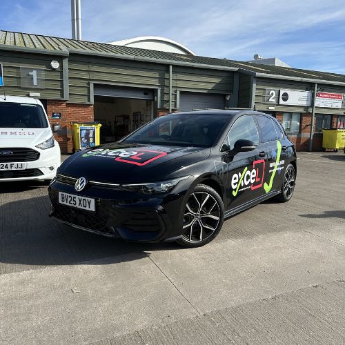 Black hatchback with driving school graphics