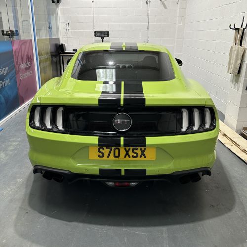 Lime green Ford Mustang with black stripes