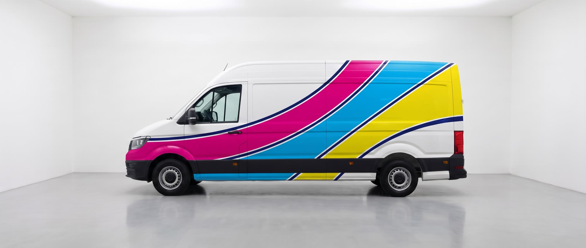 The same van after a full magenta, cyan and yellow vinyl wrap